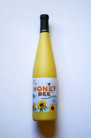 Yellow wine bottle with "Honey Bee" label.