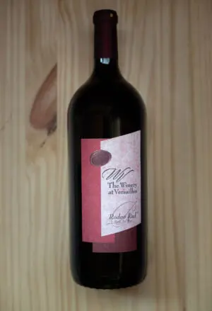 Wine bottle on wooden background.