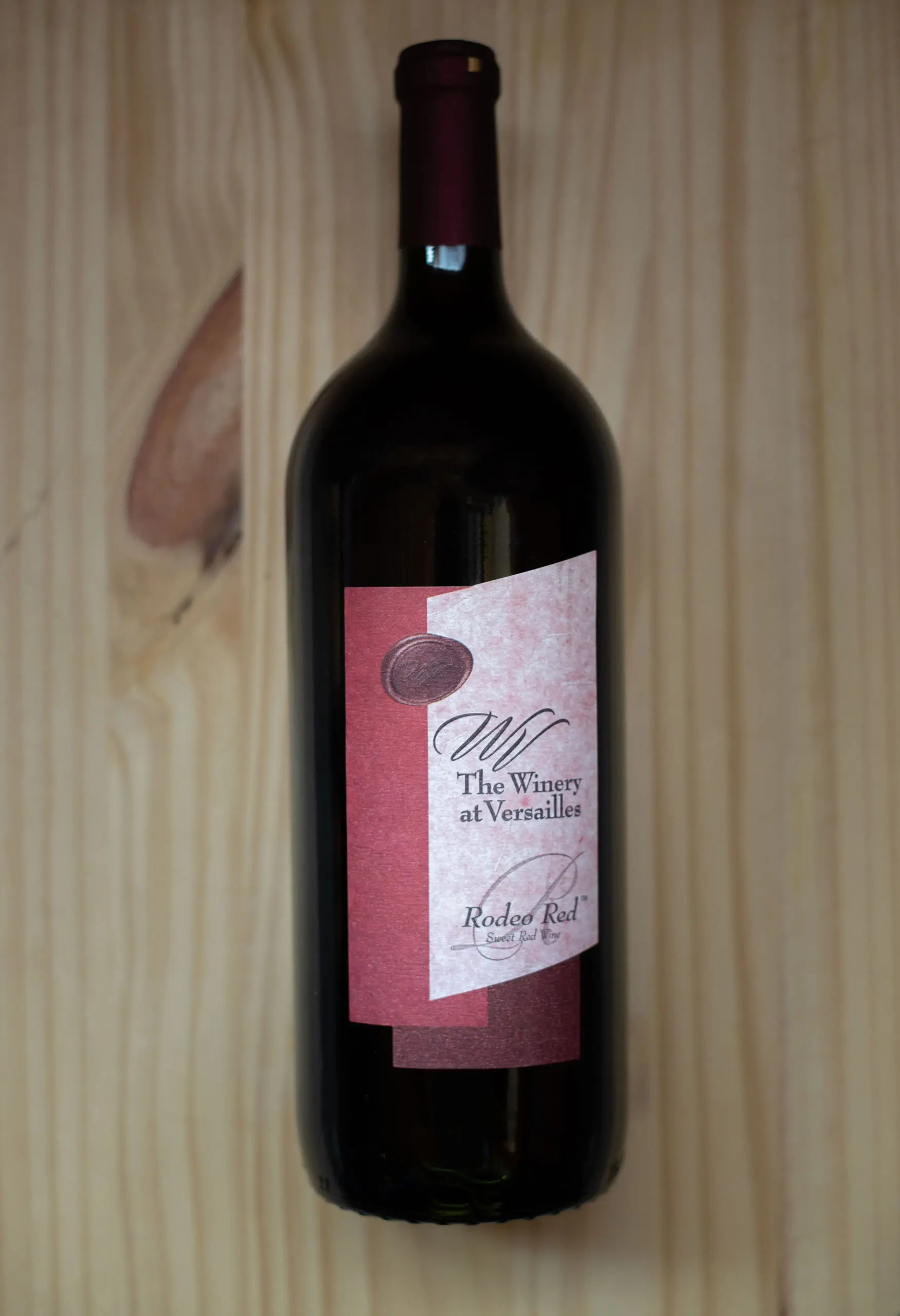 Wine bottle on wooden background.